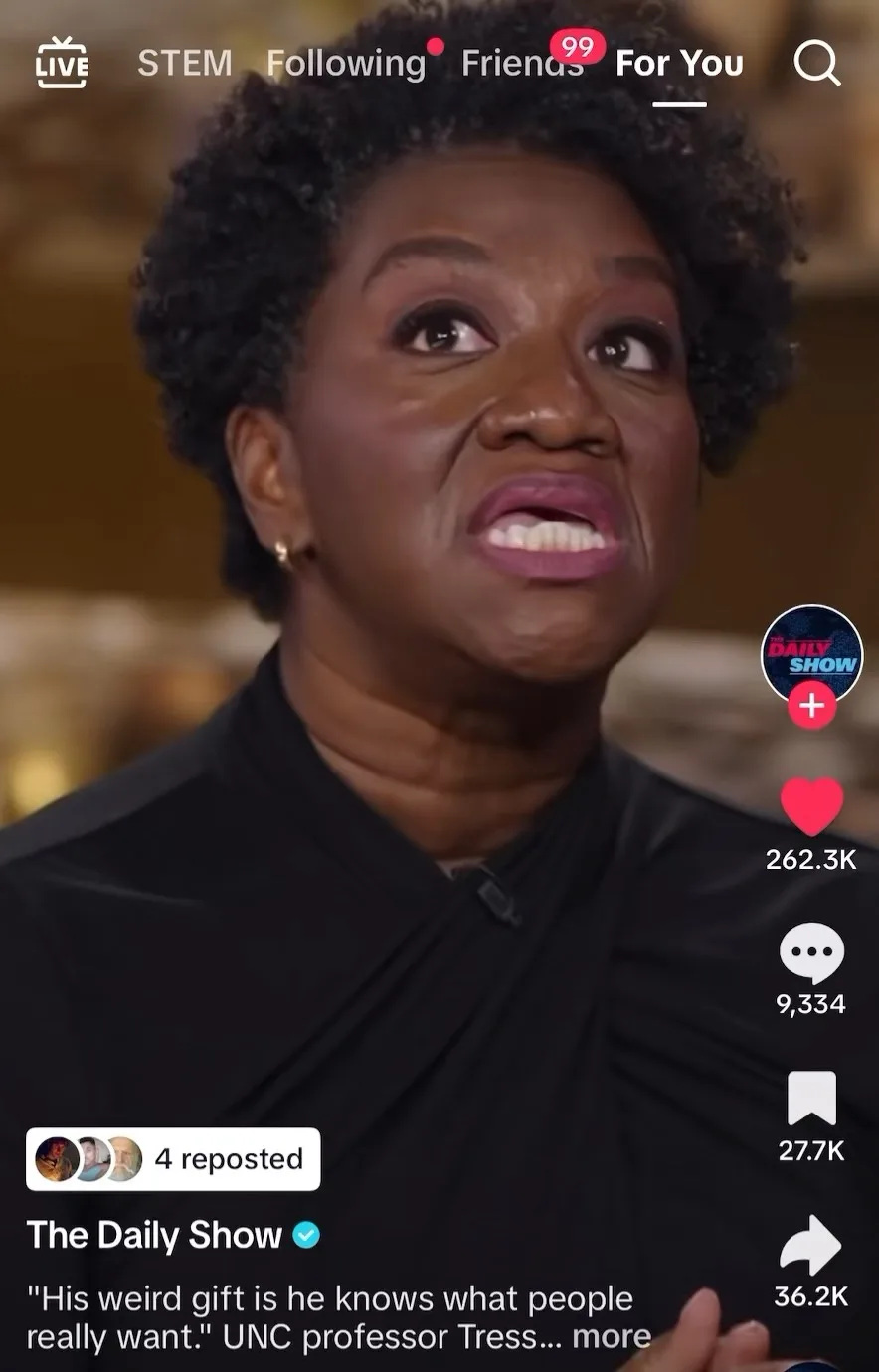 A screenshot of a TikTok video from 'The Daily Show' featuring a Black woman with short curly hair and a black top, looking…