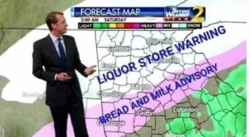 A weather forecaster stands before a forecast map showing a pink advisory zone covering cities like Atlanta and Rome…