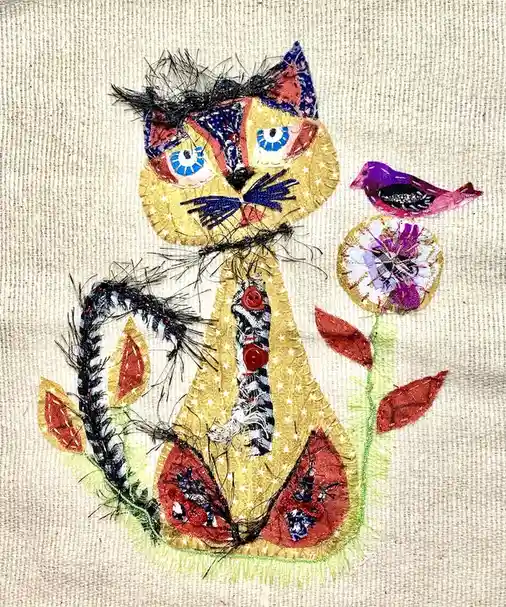A colorful, patchwork-style embroidered cat with a tie sits beside a flower and bird, with text overlaid reading 'i'm not a…