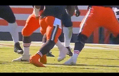 A six-panel image sequence shows a football player in orange and brown uniform being tackled, with a red circle highlighting…