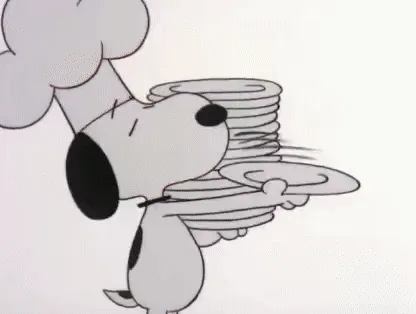 This six-panel Peanuts comic strip shows Snoopy dressed as a chef, energetically carrying plates, setting a long outdoor…
