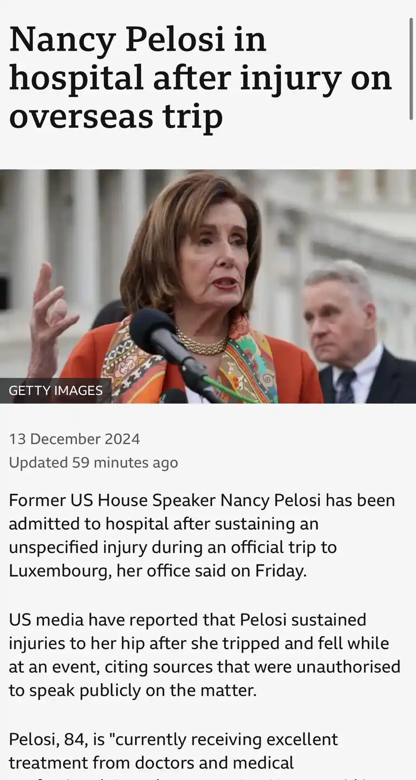 A screenshot of a news article shows a photo of Nancy Pelosi speaking at a microphone, with a man in a suit behind her. The…