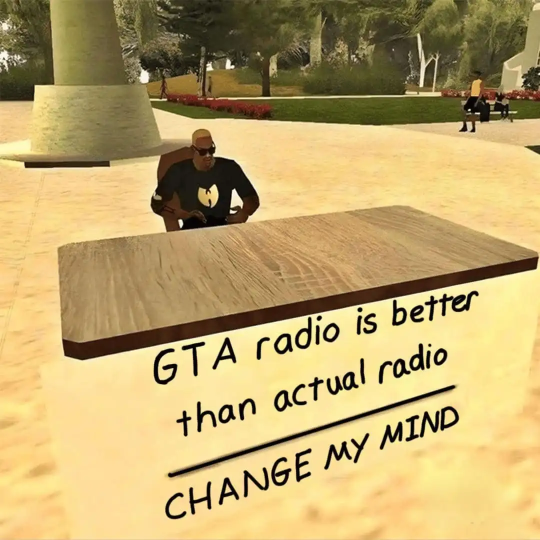 A screenshot from a video game shows a character sitting at a wooden table in a park-like setting. The character wears a…