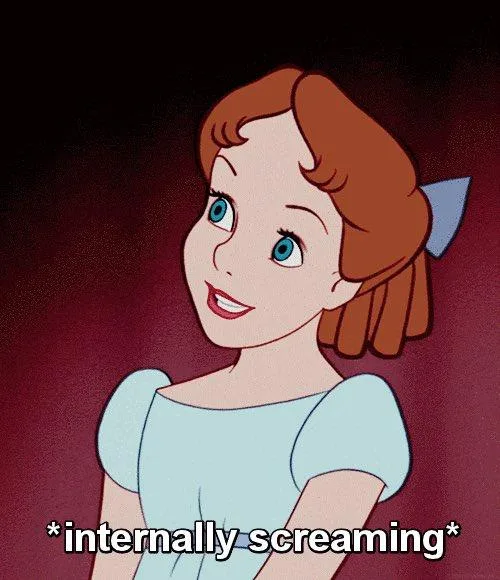 A still image of the animated character Belle from Disney's Beauty and the Beast, smiling brightly while wearing a light…