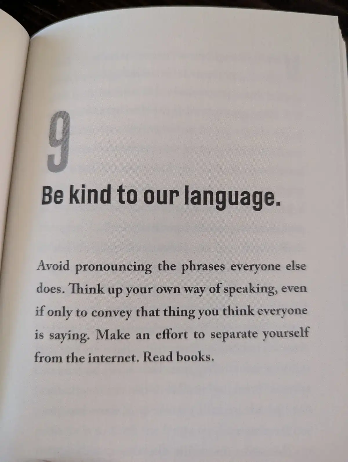 A close-up photo of a book page, numbered 9, with the heading 'Be kind to our language.' The text advises avoiding common…