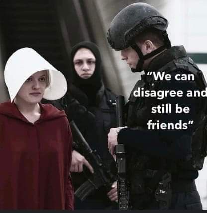 A still from 'The Handmaid's Tale' shows a woman in a red robe and white bonnet standing beside a heavily armed soldier in…