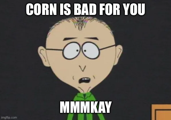 A cartoon character with glasses and a green shirt looks surprised or resigned. The text above his head says 'CORN IS BAD…