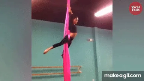 A sequence of images shows a woman in a black outfit performing aerial silk moves on a bright pink silk suspended from the…