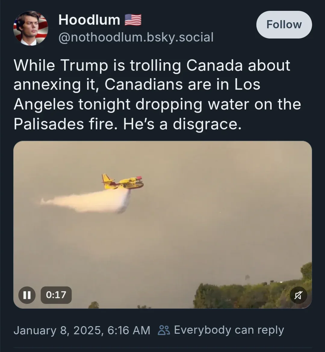 A screenshot of a social media post showing a yellow firefighting aircraft dropping water from the sky over a hazy…