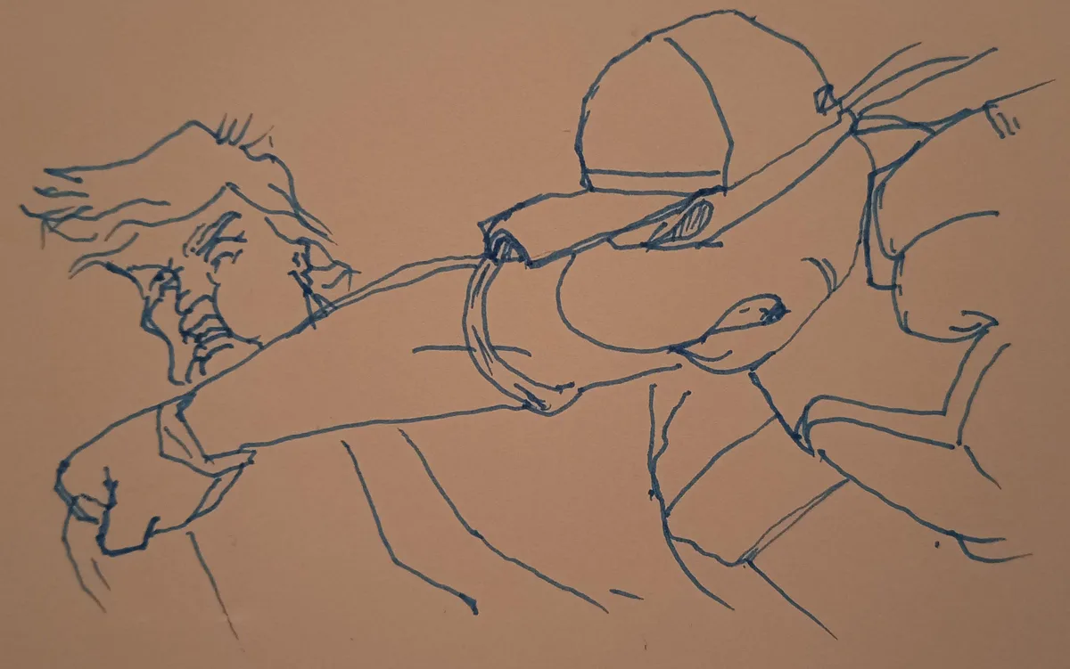 A blue ink sketch on brown paper shows a person wearing a cap and glasses, lying down with arms and legs spread out…