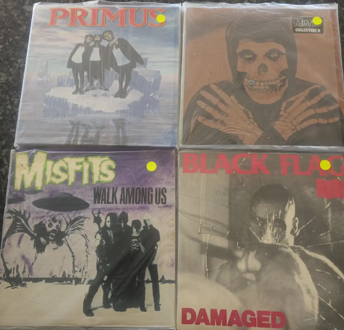 Four sealed vinyl records are arranged in a 2x2 grid, each showing its album cover: Primus' 'Tales from the Punchbowl' with…