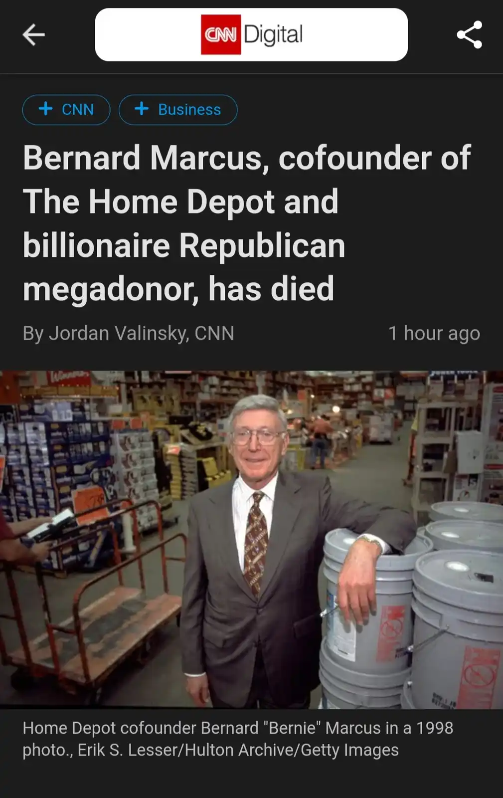 A screenshot of a CNN Digital news article announcing the death of Bernard Marcus, showing a 1998 photo of him smiling in a…