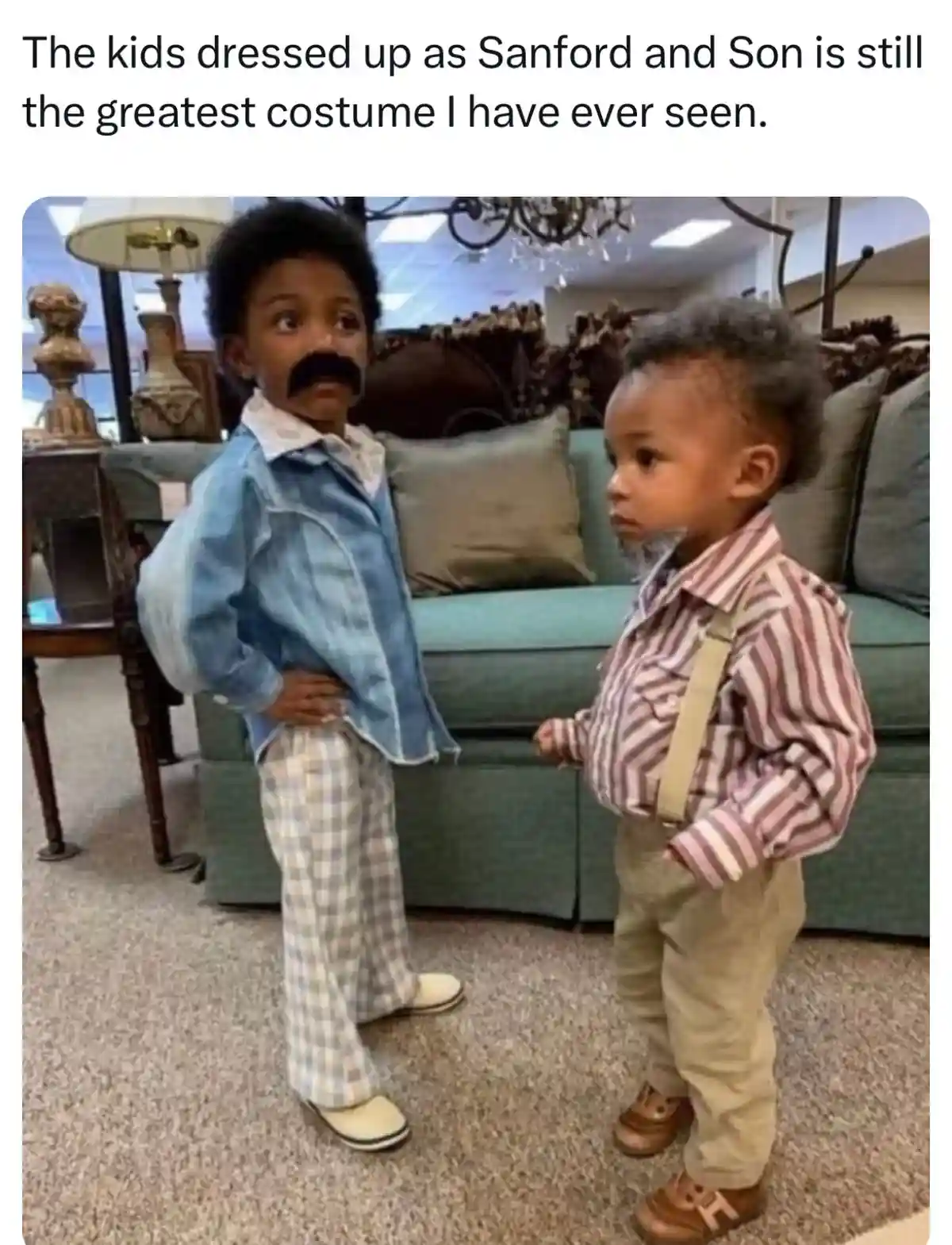 Two young Black boys are dressed as characters from the TV show 'Sanford and Son,' with one wearing a fake mustache and…