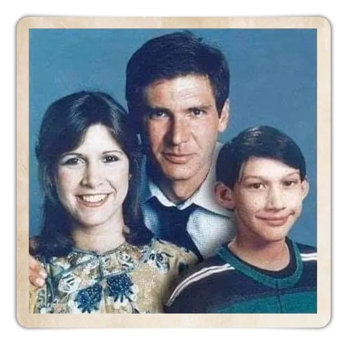 A vintage family portrait shows a man, a woman, and a young boy posing together against a blue backdrop. The man in the…