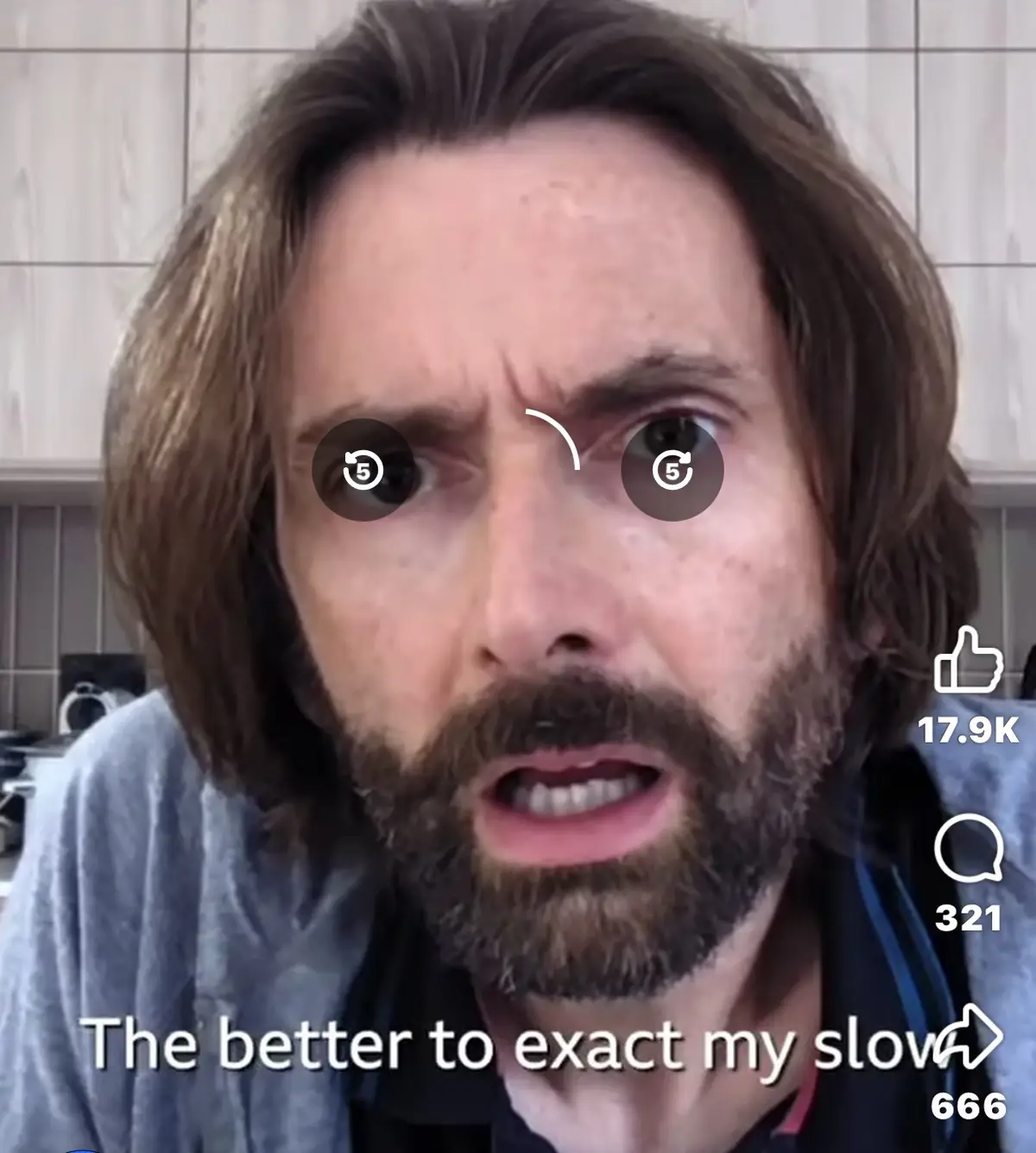 A man with long brown hair and a beard looks intensely at the camera with a furrowed brow, his eyes overlaid with circular…