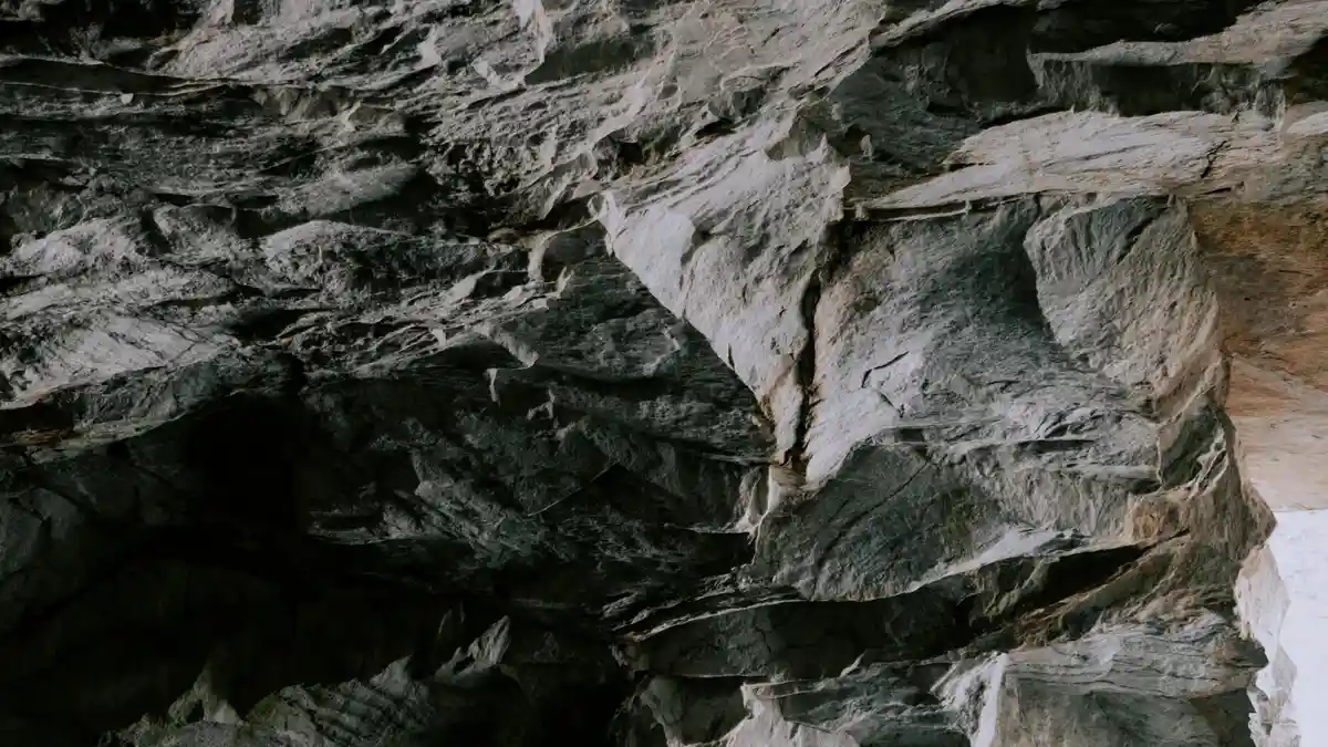 Darkness yields to twinkling crystals as the camera's gaze descends into the cave's heart. Turquoise waters lap gently…