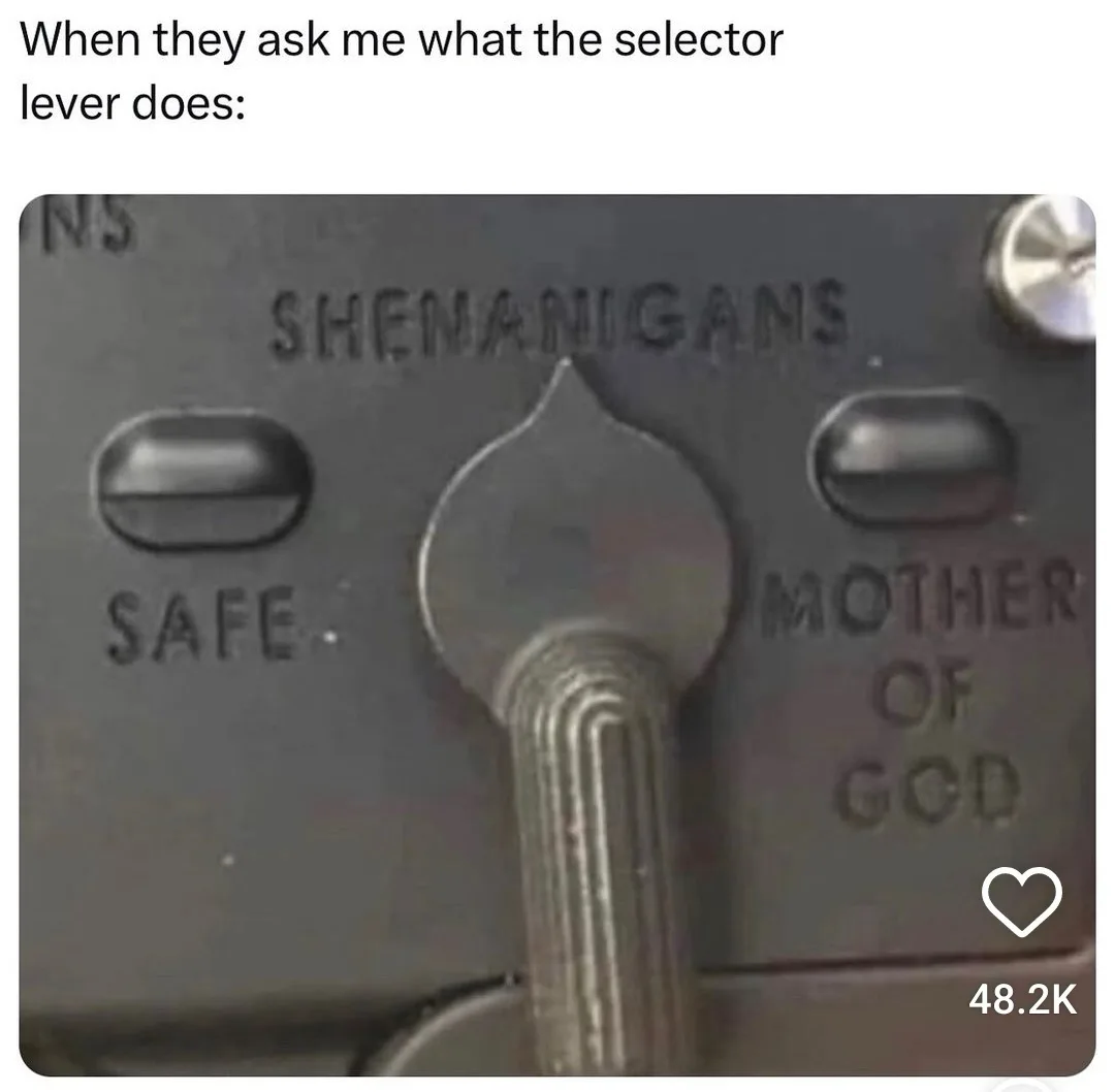 A close-up photo of a mechanical selector lever on a metal panel, with three positions labeled 'SAFE', 'SHENANIGANS', and…