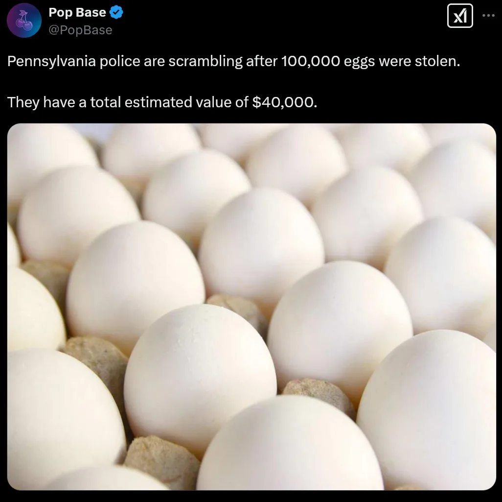 A close-up photo shows a large quantity of white chicken eggs nestled in a cardboard egg carton. Overlaid text from a tweet…