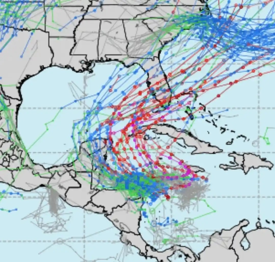 A weather map of the Caribbean and southeastern United States shows a dense, chaotic tangle of colored lines and dots…