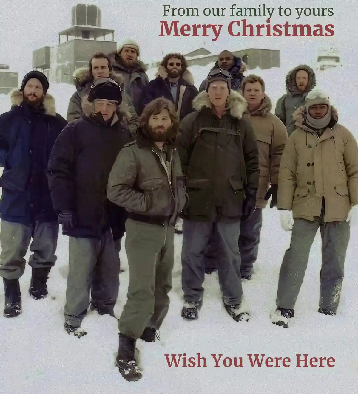 A group of men in heavy winter gear stand in a snowy, barren landscape with buildings in the background. The image is…