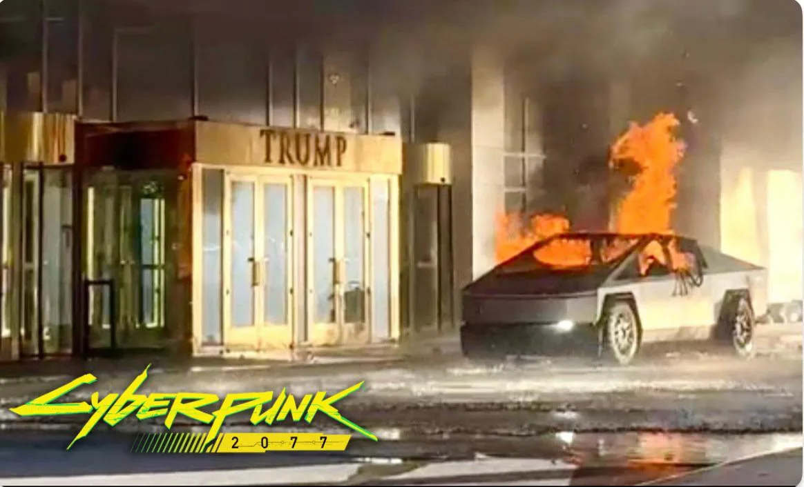 A Tesla Cybertruck is engulfed in flames on a wet street in front of a building with a 'TRUMP' sign above its entrance. The…