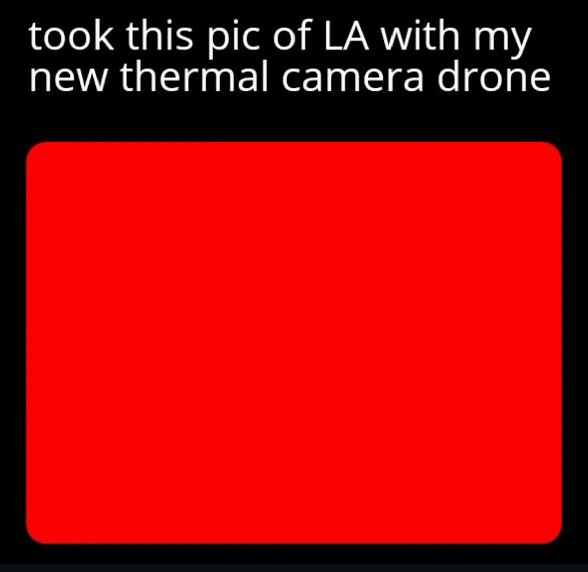 The image displays a solid red rectangle on a black background, with white text at the top stating 'took this pic of LA with…