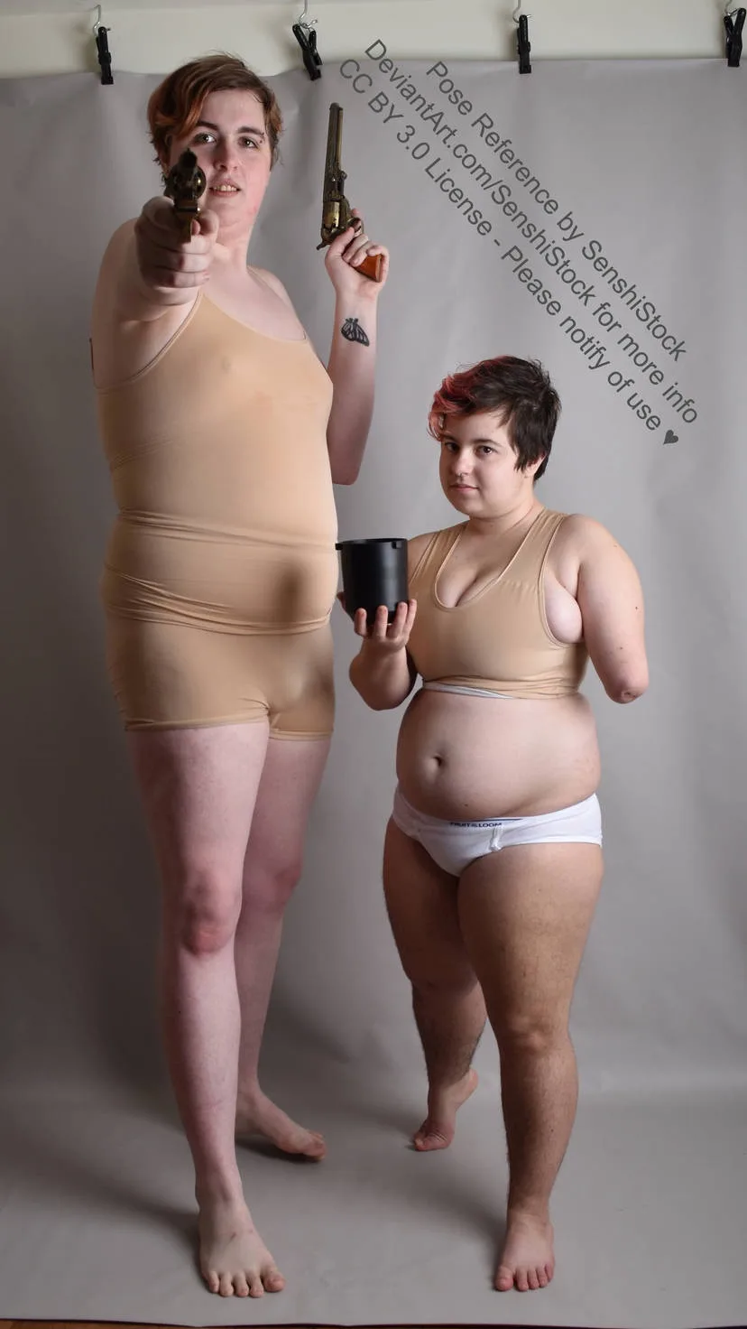 Two people stand against a plain backdrop, both wearing beige bodysuits and underwear. The taller person holds two…
