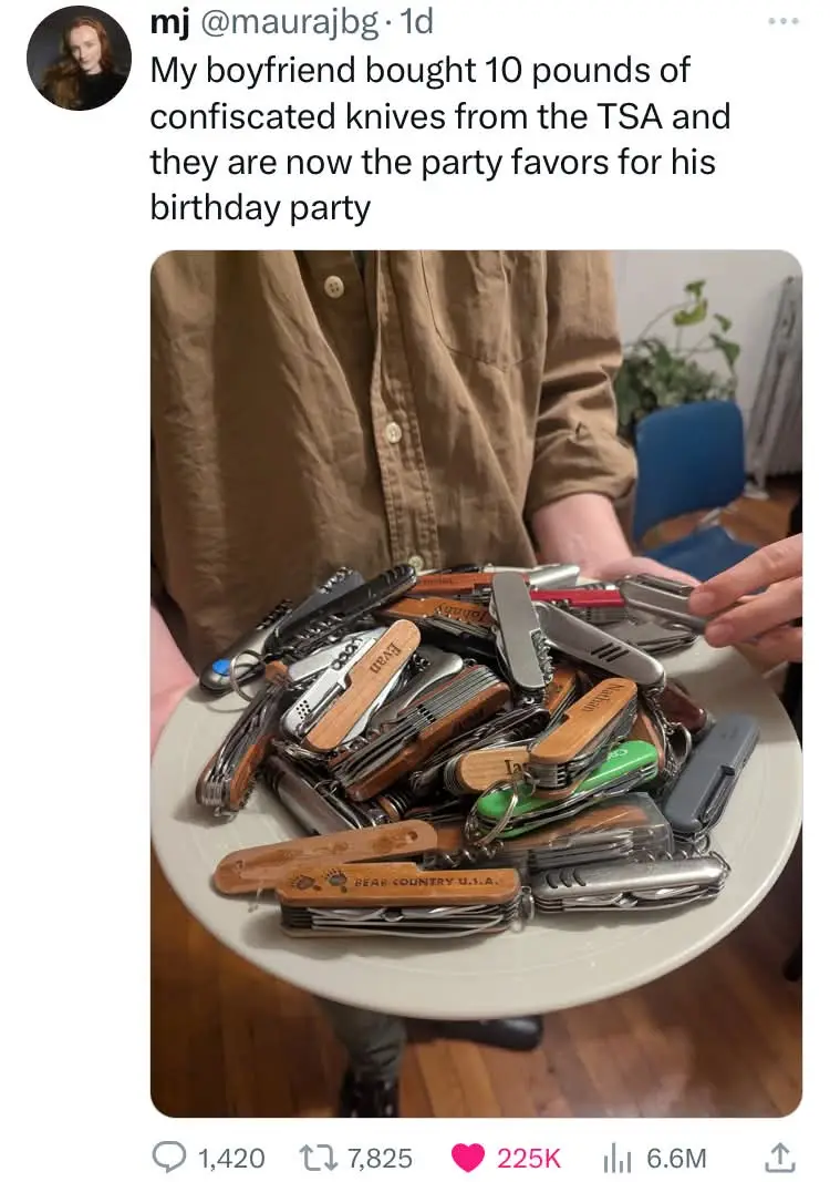 A person holds a white plate piled high with dozens of multi-tools and pocket knives, many with wooden handles and engraved…