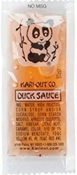 A close-up of a Kari-Out Co. duck sauce packet, featuring a cartoon panda holding bamboo stalks. The packaging lists…