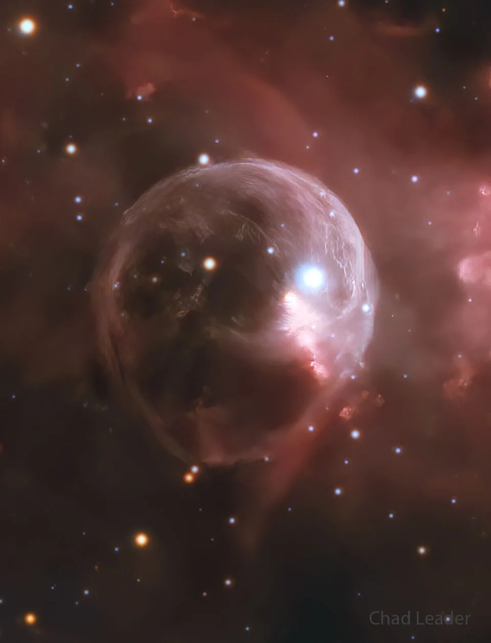 A cosmic image shows a glowing, spherical nebula with bright stars and reddish gas clouds in the background. The text 'Chad…