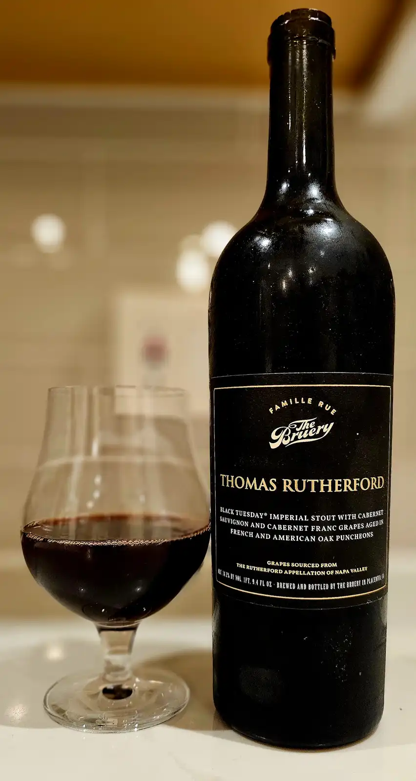 A dark bottle of 'Thomas Rutherford' beer, labeled as a 'Black Tuesday Imperial Stout with Cabernet Sauvignon and Cabernet…