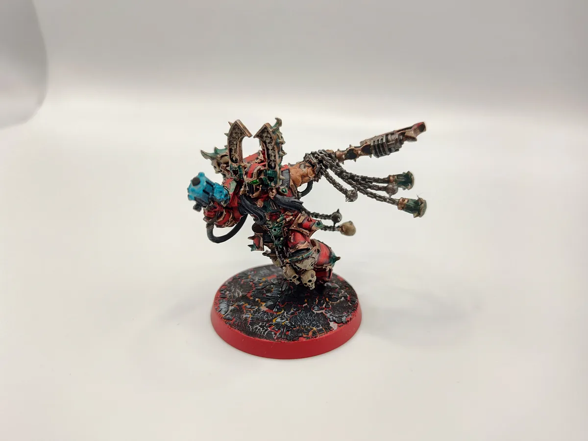 A heavily detailed, custom-painted miniature of a fantasy warrior with red, green, and blue armor, wielding a large weapon…
