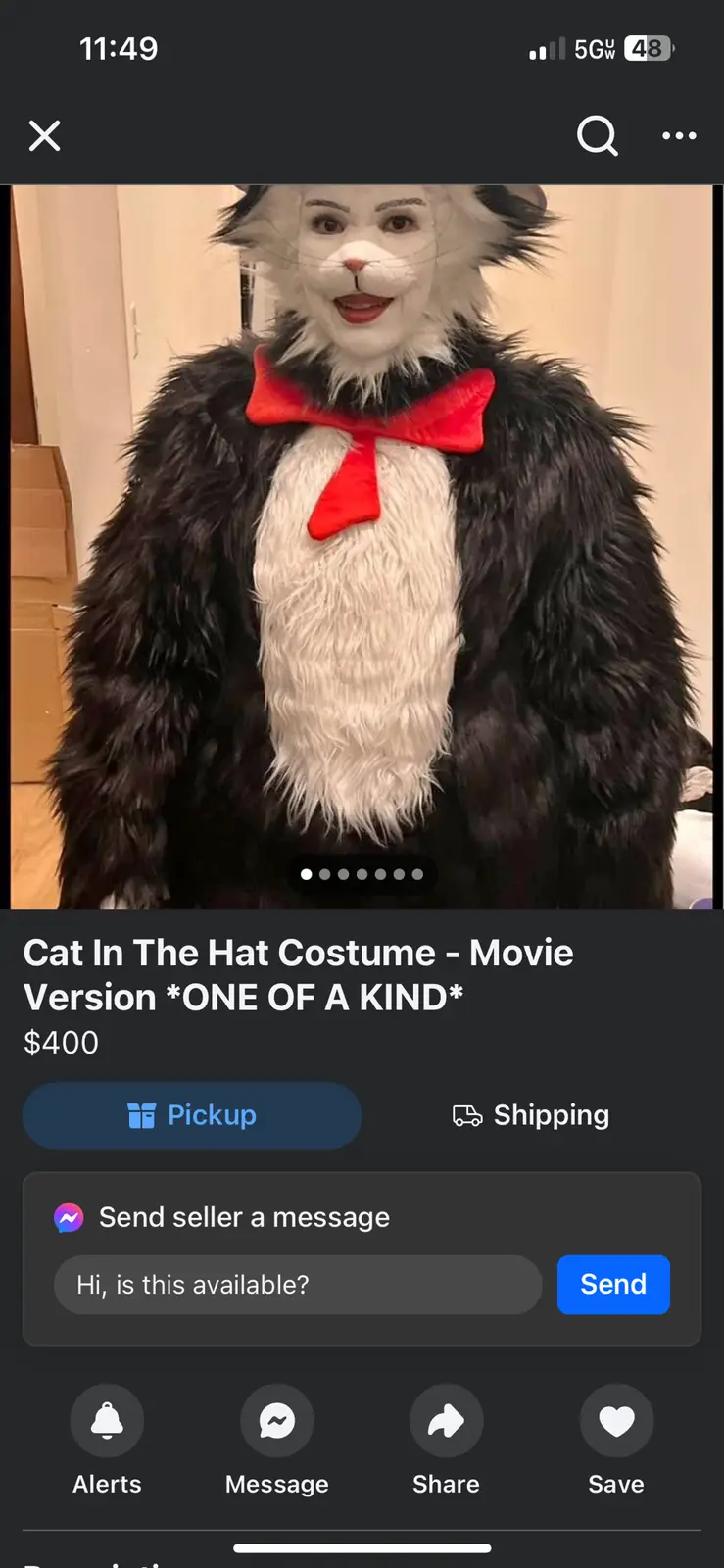 A person wearing a full-body Cat in the Hat costume with black and white fur, a red bow tie, and a cat mask, is shown in a…