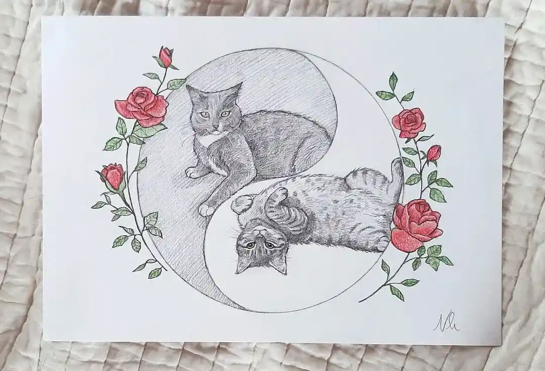 A pencil drawing shows two cats positioned within a yin-yang symbol, one sitting upright in the white half and the other…