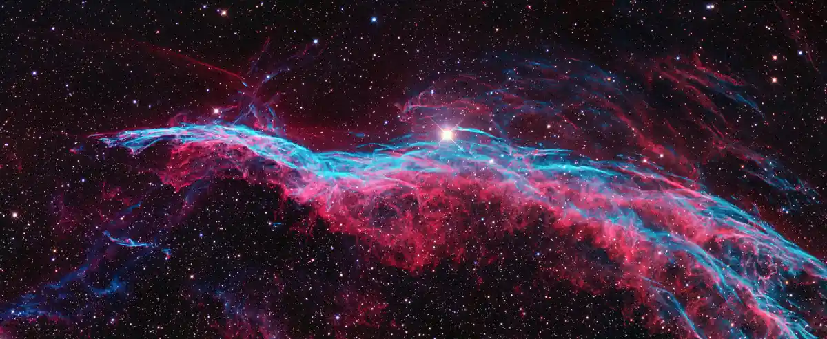 A vibrant space nebula image with swirling red and blue cosmic clouds against a star-filled black background, overlaid with…