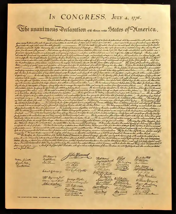 A historical image of the Declaration of Independence, dated July 4, 1776, with its full text and signatures visible. The…