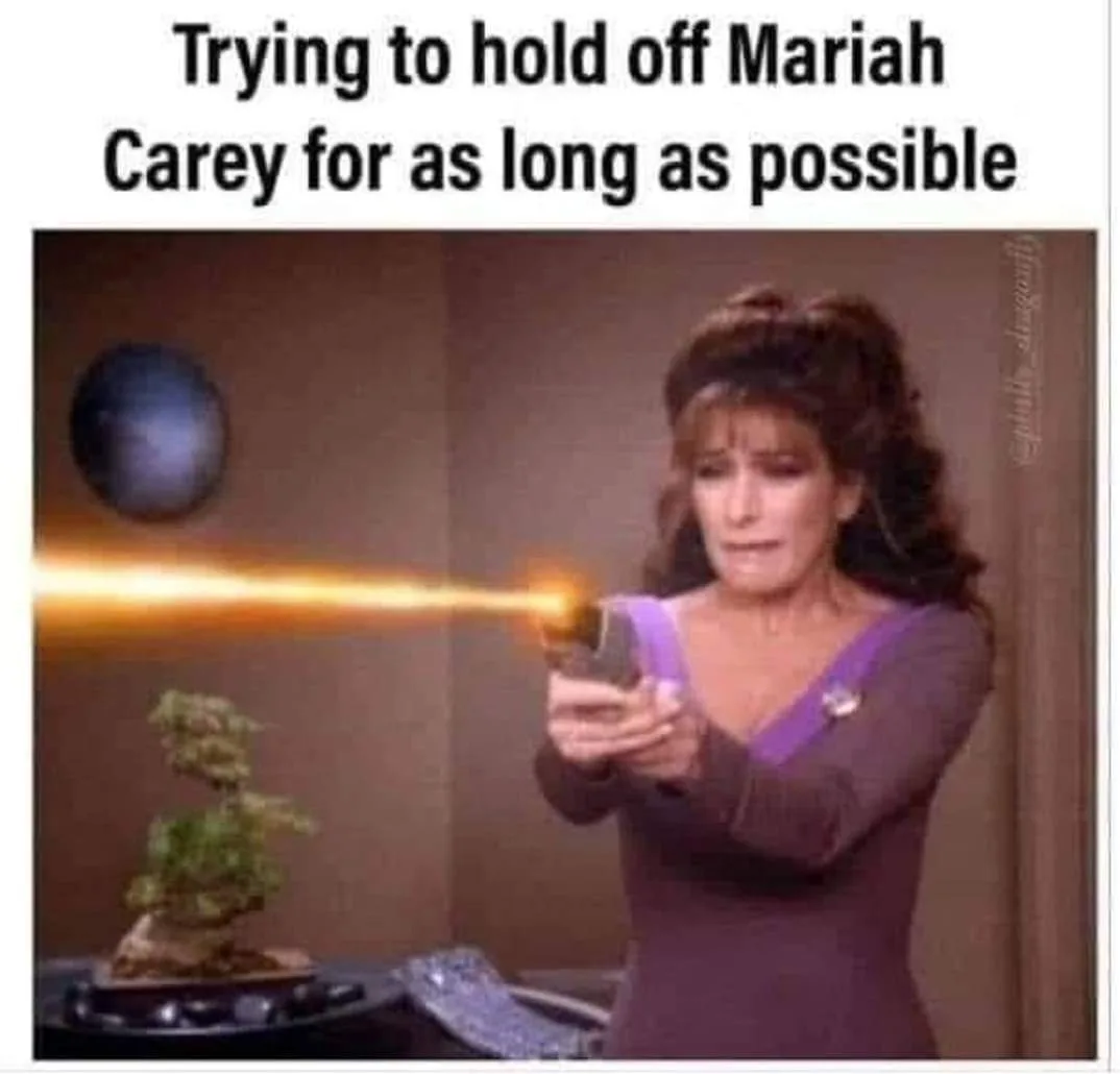 A woman in a Star Trek-style uniform aims a phaser that emits a bright orange beam at a small bonsai tree. The text overlaid…