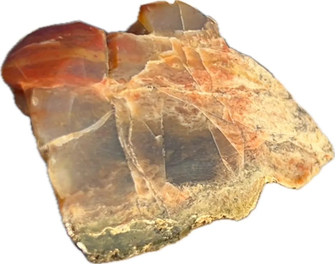 A rough, unpolished piece of translucent agate with layered bands of red, orange, beige, and gray, set against a plain black…
