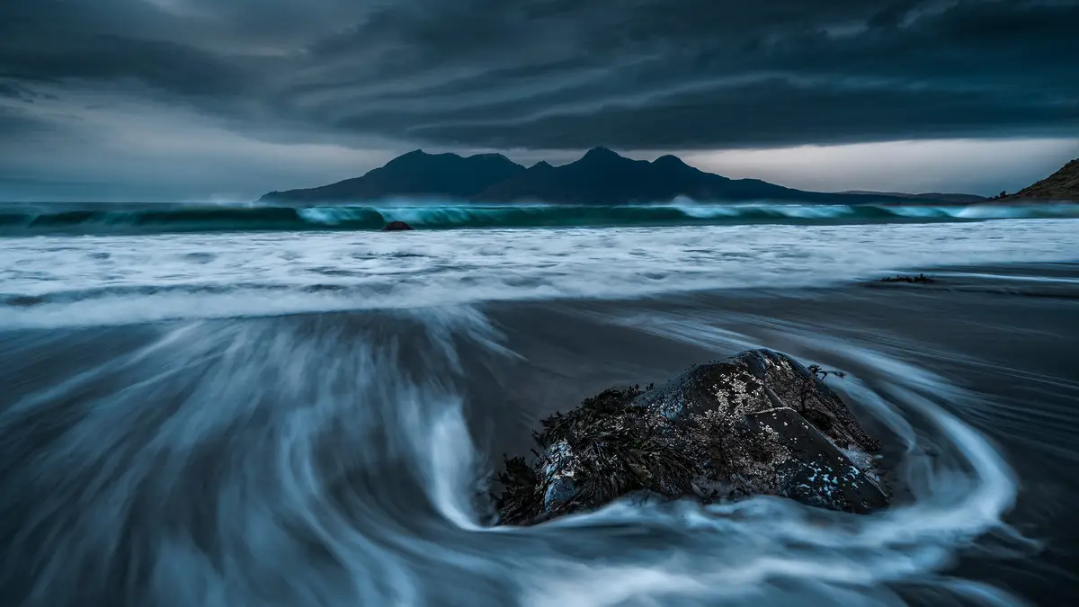 Standing on Eigg's flat tidelands, we gaze at RÃÂ¹m's distant sawtooth hills, two islands part of a 150-person archipelago…