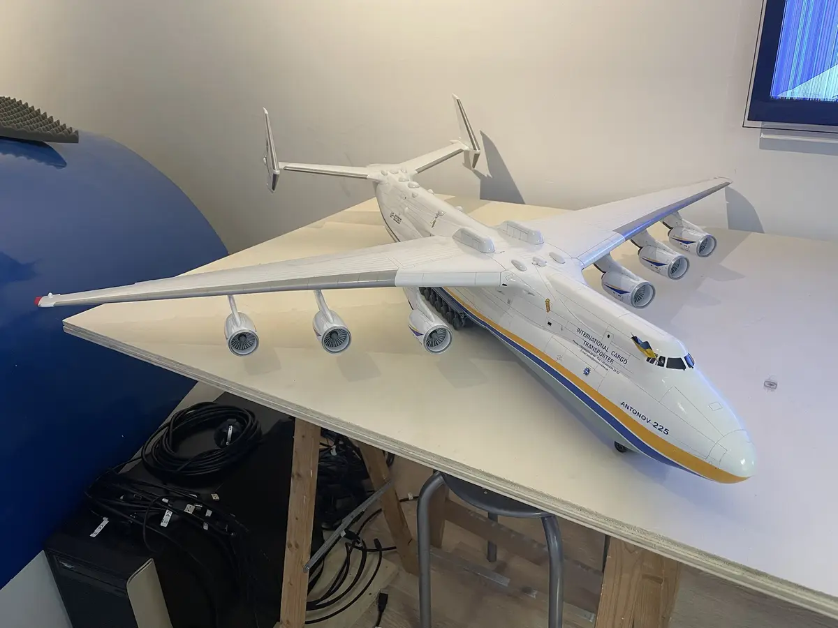 A large white model of the Antonov An-225 Mriya cargo plane, labeled 'INTERNATIONAL CARGO TRANSPORTER' and 'ANTONOV-225', is…