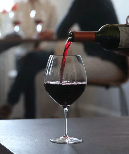 A six-panel image sequence shows red wine being poured into a wine glass from a bottle, with the liquid level rising in each…