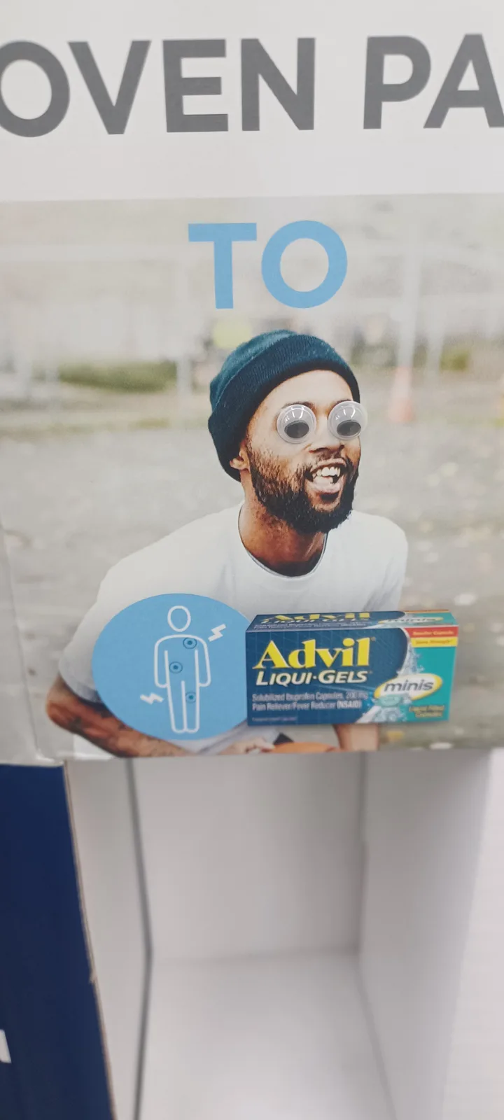 A man in a beanie and googly eyes holds a box of Advil Liqui-Gels minis next to a pain relief icon, with the text 'OVEN PAIN…