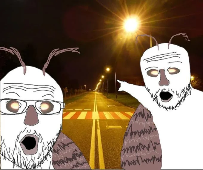 Two cartoonish, white-faced figures with exaggerated features and antennae stand on either side of a nighttime street, one…