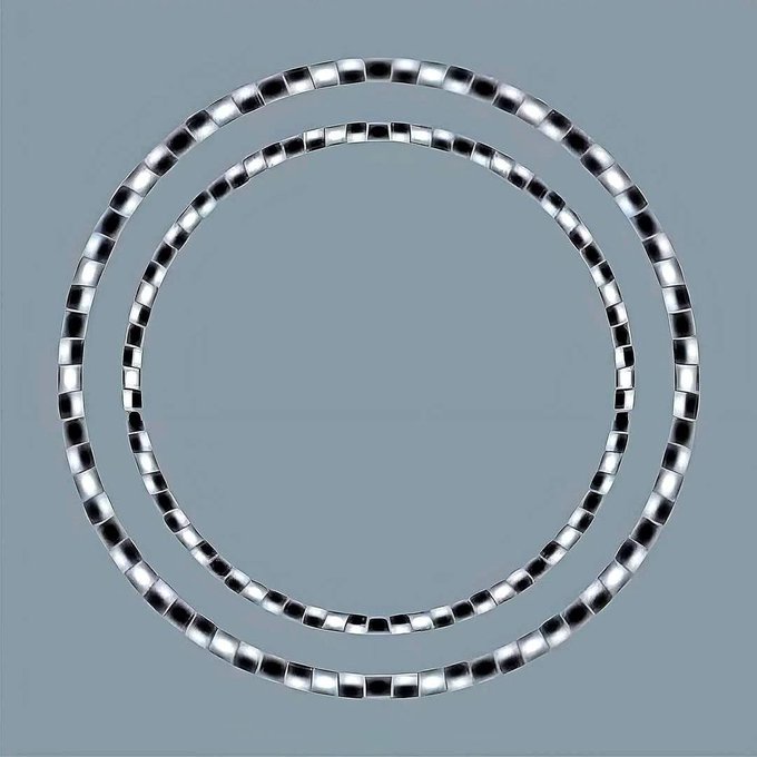 Two concentric circles made of shiny, reflective, square-shaped beads are set against a plain gray background. The overlaid…