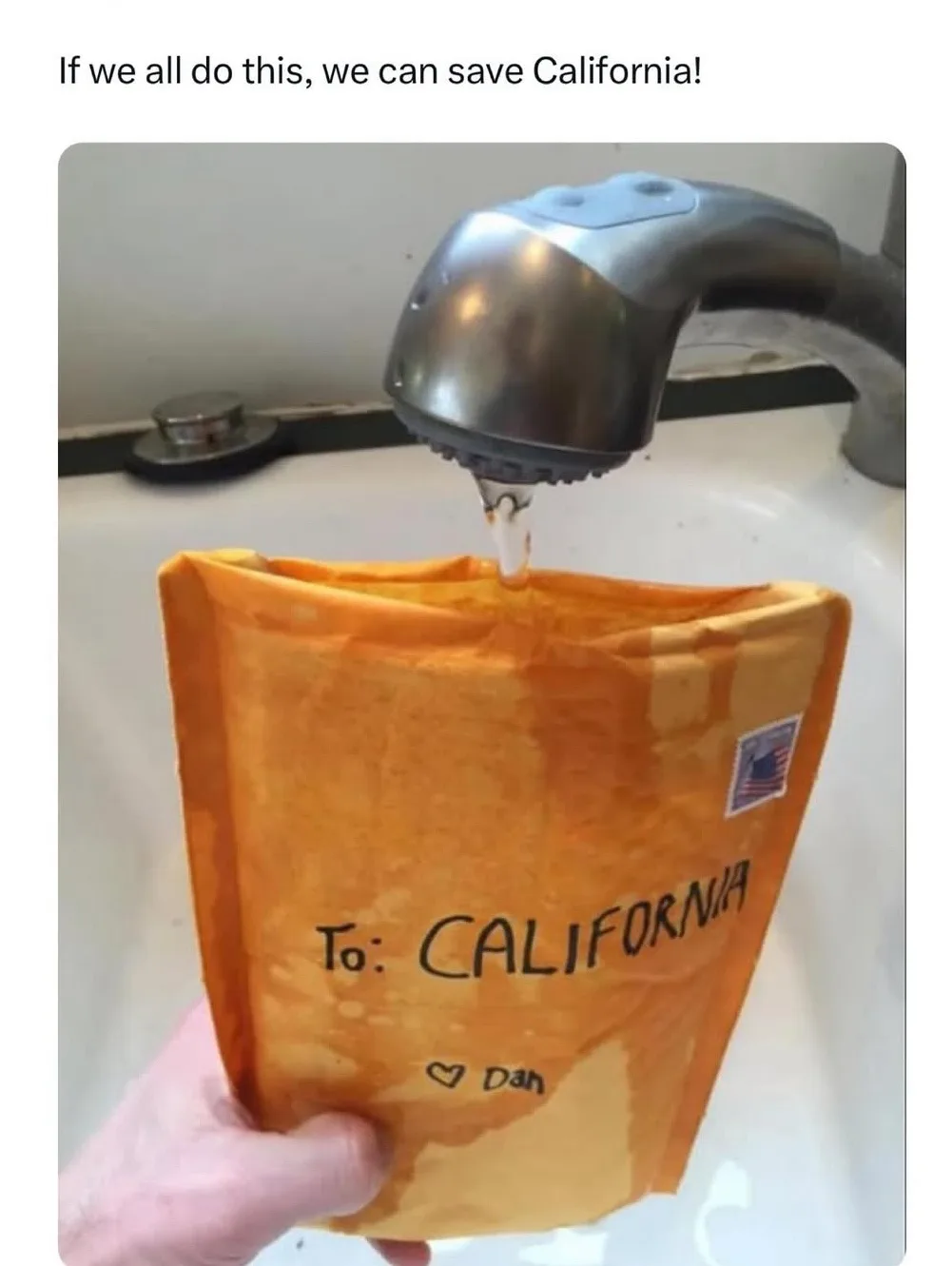 A hand holds an orange reusable shopping bag under a running faucet, with water filling it. The bag has handwritten text…