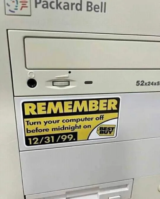 A close-up of a beige Packard Bell computer case with a Best Buy sticker that reads 'REMEMBER Turn your computer off before…