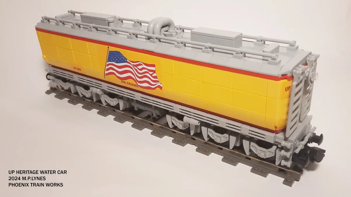 A detailed LEGO model of a yellow and gray Union Pacific heritage water car, featuring an American flag decal and the name…
