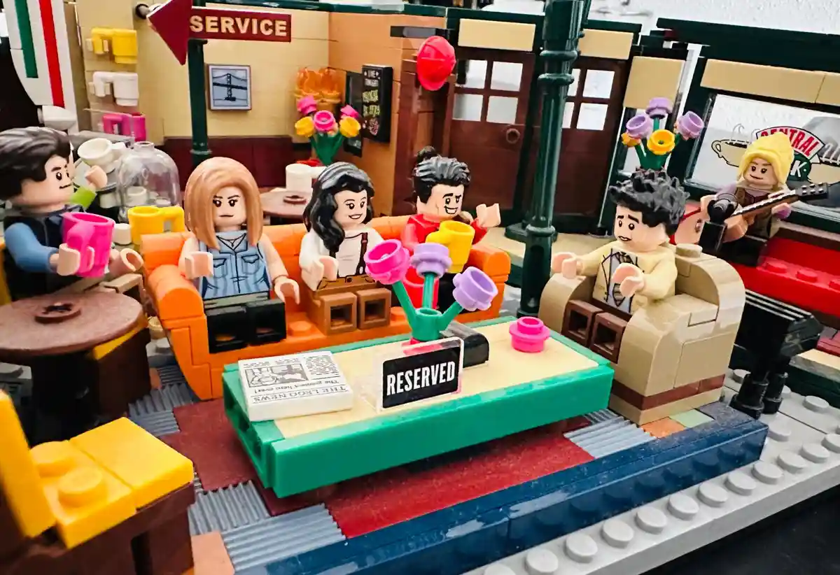 A LEGO recreation of the Central Perk coffee shop from the TV show 'Friends,' featuring LEGO minifigures of the main…