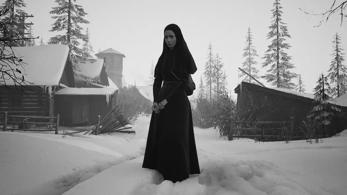 A woman in a black nun's habit stands in deep snow in a rural, snowy setting with wooden cabins and pine trees. The image is…