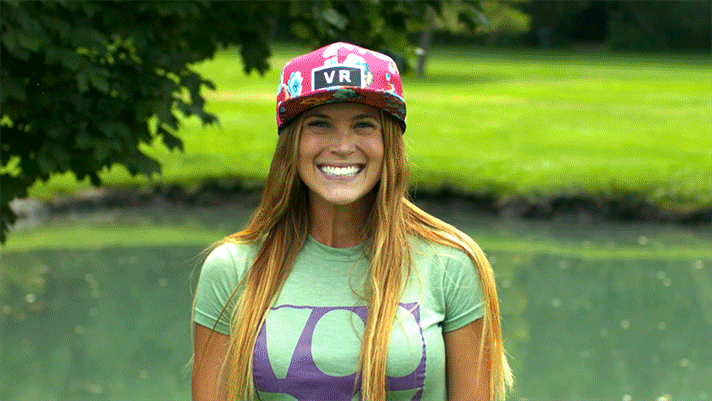 A six-panel image sequence shows a woman in a green shirt and pink VR-themed cap. Initially smiling, she then has a large…